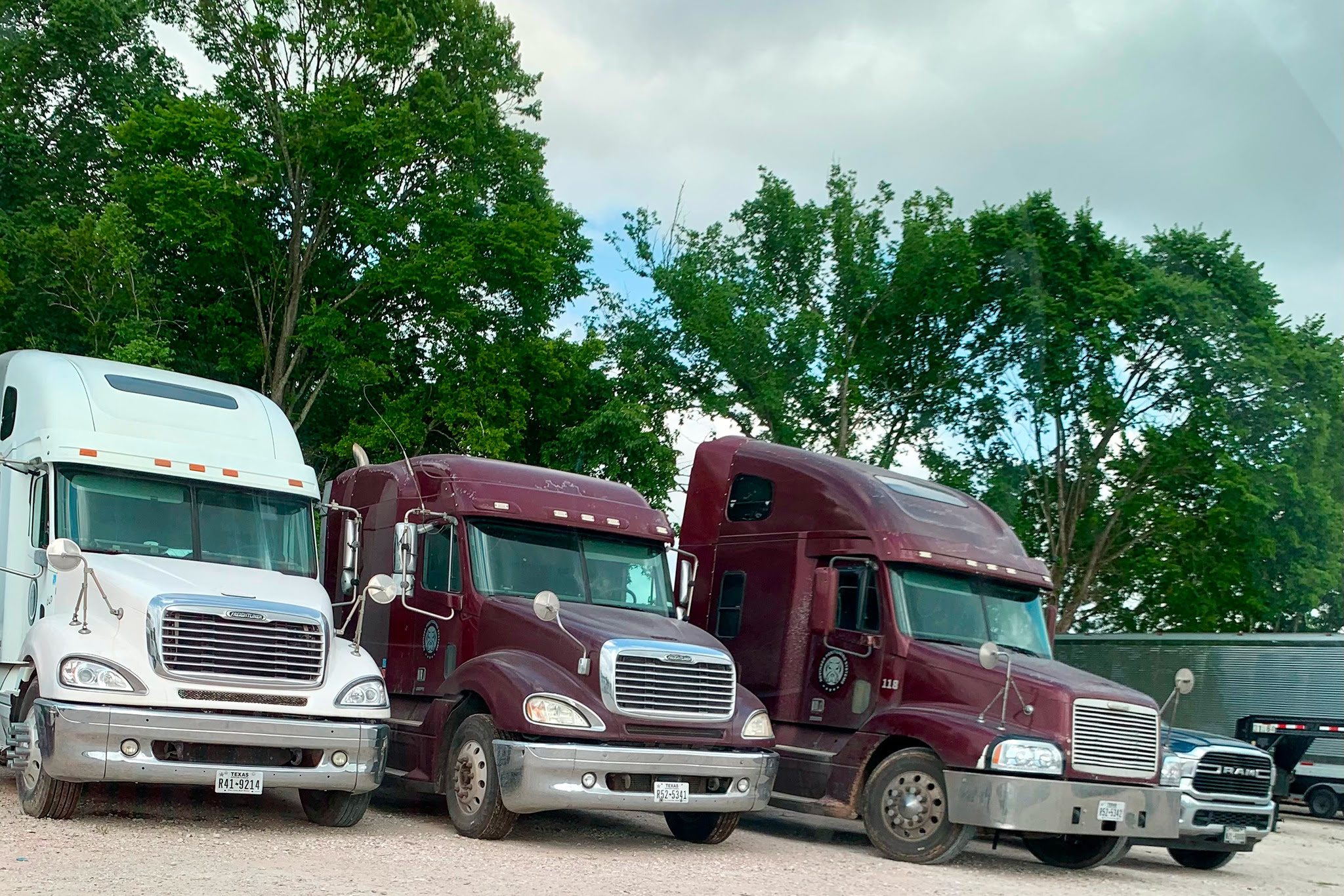 Large trucks on gravel lot